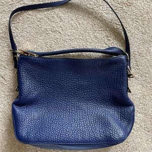 Blue Burberry Bag. Can be worn crossbody and also has a top handle.